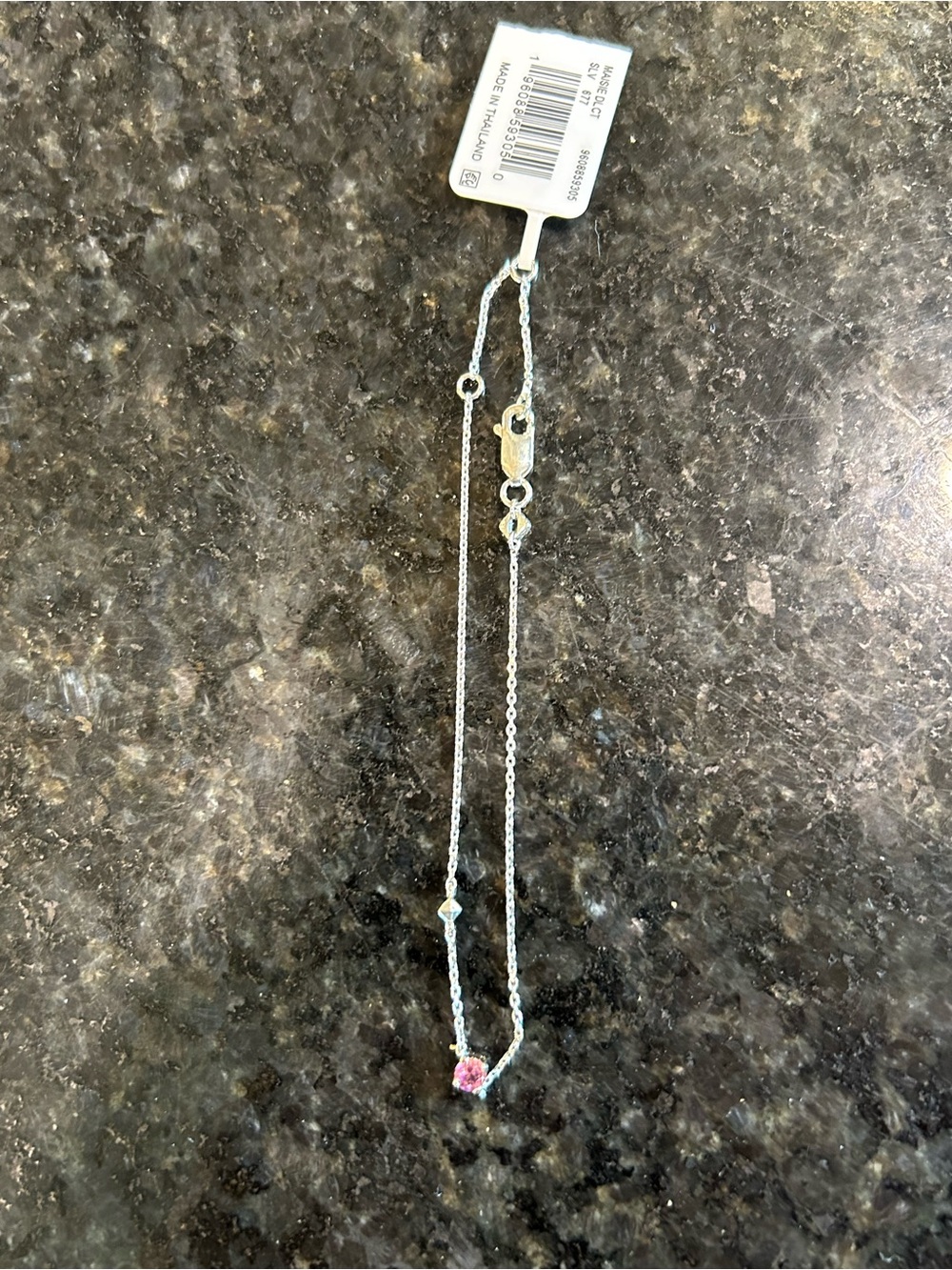 Kendra Scott silver bracelet.